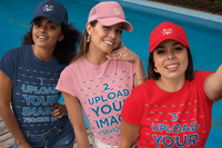 Three beautiful young women wearing Ethi-Cali vegan trucker hats while poolside on a summer day