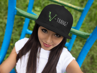 Young women wearing a black vegan snap back hat